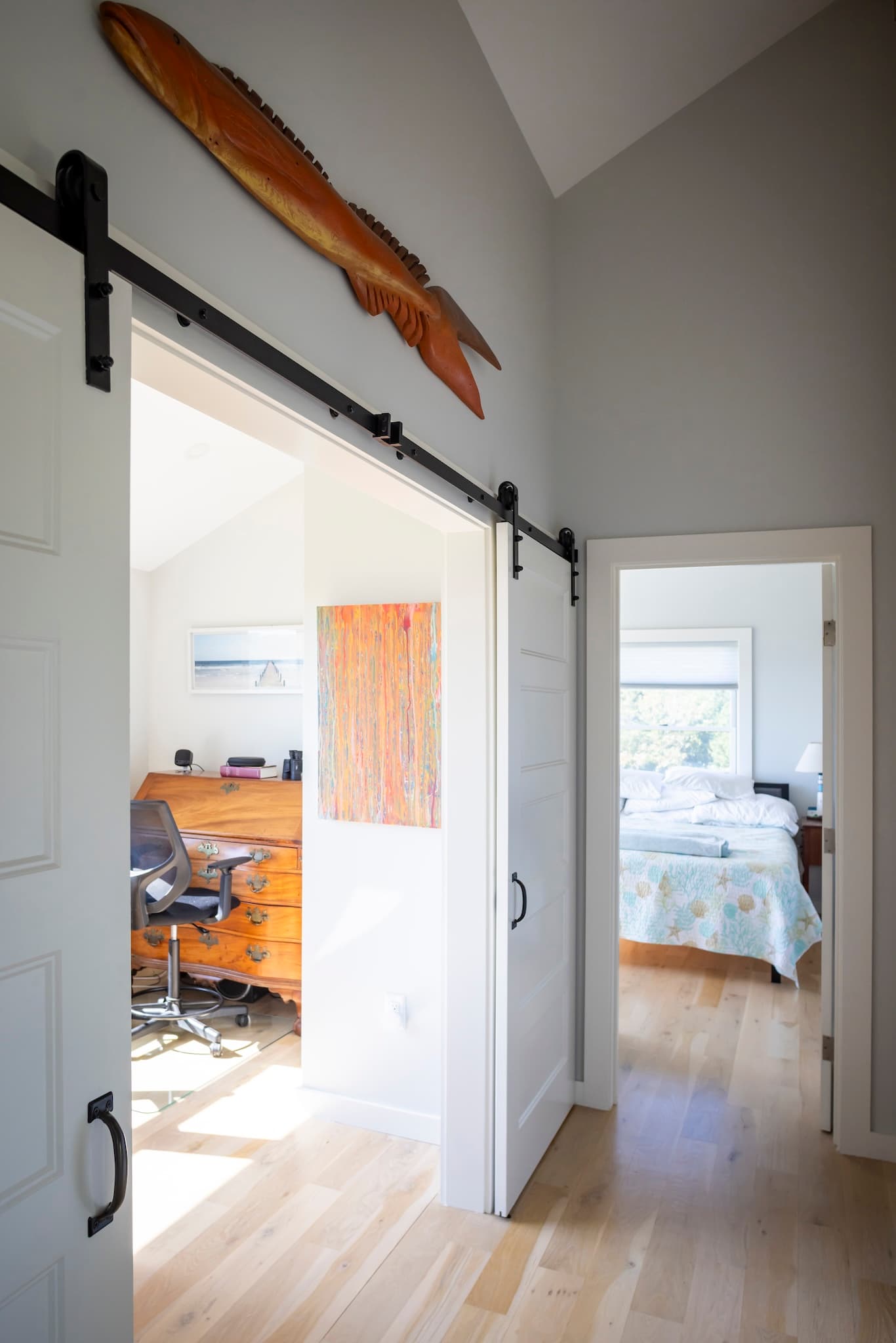 Entryways to a home office with barn door and private bedroom